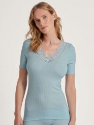 Calida Wełniana koszulka w kolorze błękitnym rozmiar: XS. Niebieskie koszulki damskie Calida, xs, bez wzorów, z koronki, bez kołnierzyka, bez ramiączek. Za 156.98 zł.