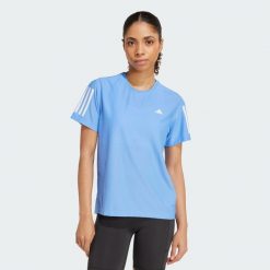 Koszulka Own The Run. Niebieskie koszulki damskie Adidas, s, bez wzorów, z materiału, bez kołnierzyka, bez ramiączek. Za 149.00 zł.