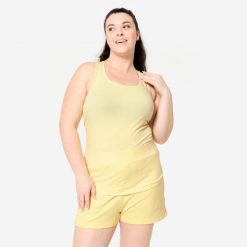 Koszulka bez rękawów damska Domyos Gym & Pilates slim. Żółte koszulki damskie DOMYOS, l, bez wzorów, z bawełny, bez kołnierzyka, bez ramiączek. W wyprzedaży za 19.99 zł.