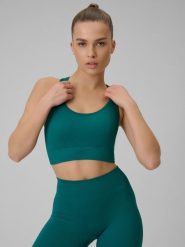 4F Biustonosz treningowy bezszwowy z niskim wsparciem damski - turkusowy XS/S. Niebieskie biustonosze sportowe damskie 4F, bez wzorów, z materiału. Za 89.99 zł.