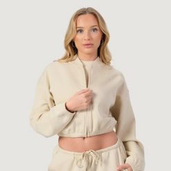 Bluza damska fitness z zamkiem bez kaptura migdałowa NEO. Brązowe bluzy damskie GYMBEAM, l, bez wzorów, z bawełny, bez kaptura. Za 119.90 zł.