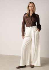 Białe Szerokie Spodnie Wiskozowe w Garniturowym Stylu z Paskiem Qera. Białe spodnie materiałowe damskie Born2be, bez wzorów, z jeansu. Za 129.99 zł.