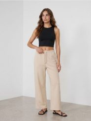 Spodnie dresowe wide leg - beżowy. Brązowe spodnie sportowe damskie Sinsay, l, bez wzorów, z dresówki, na fitness i siłownię. Za 39.99 zł.