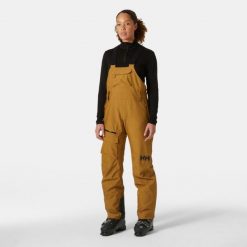Damskie spodnie narciarskie na szelkach Helly Hansen Powderqueen. Brązowe spodnie sportowe damskie Helly Hansen, na zimę, bez wzorów, narciarskie. W wyprzedaży za 1,208.00 zł.