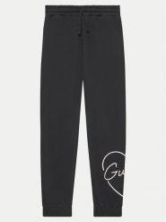 Guess Spodnie dresowe J4YQ16 KA6R3 Czarny Relaxed Fit. Czarne spodnie dresowe dziewczęce Guess, z aplikacjami, z bawełny. Za 109.99 zł.