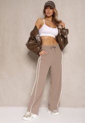 Brązowe Szerokie Spodnie Dresowe High Waist Zdobione Lampasami Sopaline. Brązowe spodnie dresowe damskie Renee, l, z aplikacjami, z dresówki. Za 49.99 zł.