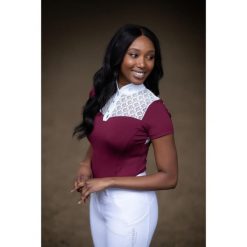 Damska koszulka do jazdy konnej Equestrian Stockholm Champion. Czerwone koszulki damskie EQUESTRIAN STOCKHOLM, bez wzorów, bez kołnierzyka, bez ramiączek. Za 408.50 zł.