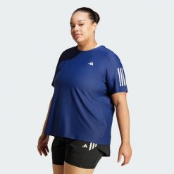 Koszulka Own The Run (Plus Size). Białe bluzki damskie Adidas, plus size, bez wzorów, z materiału, sportowe, bez kołnierzyka, plus size, bez ramiączek. Za 159.00 zł.