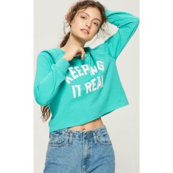 Bluza z nadrukiem - Turkusowy. Niebieskie bluzy damskie Sinsay, z nadrukiem. W wyprzedaży za 19.99 zł.