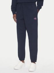 Calvin Klein Jeans Spodnie dresowe Monologo LV047B235G Granatowy Regular Fit. Niebieskie spodnie dresowe damskie Calvin Klein Jeans, s, bez wzorów, z bawełny. Za 329.99 zł.