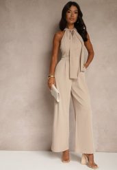 Beżowy Kombinezon Wide Leg z Ozdobnym Wiązaniem przy Szyi Silelia. Brązowe sukienki damskie Renee, bez wzorów, eleganckie, bez ramiączek. W wyprzedaży za 111.99 zł.