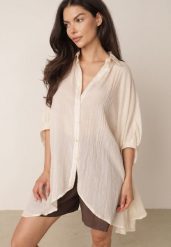 Beżowa Zwiewna Koszula Letnia Oversize z Bawełny o Nietoperzowym Kroju Canomela. Brązowe koszule damskie Born2be, na lato, l, bez wzorów, z bawełny, eleganckie, bez kołnierzyka, bez ramiączek. Za 139.99 zł.