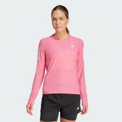 Koszulka Own The Run Long Sleeve. Czerwone koszulki damskie Adidas, s, bez wzorów, z materiału, bez kołnierzyka, bez ramiączek. Za 189.05 zł.