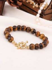 L'Atelier de Gaia Pozłacana bransoletka z tygrysim okiem rozmiar: onesize. Brązowe bransoletki damskie L'Atelier de Gaia, pozłacane. Za 87.40 zł.