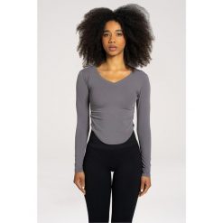 Koszulka fitness damska Gym Glamour wycięta z długimi rękawami. Niebieskie koszulki damskie GYM GLAMOUR, s, bez wzorów, bez kołnierzyka, bez ramiączek. Za 149.99 zł.