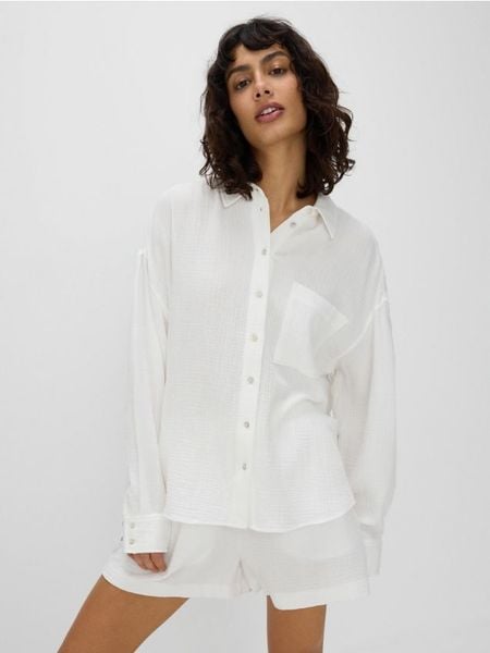 Koszula z bawełnianego muślinu - biały. Białe koszule damskie Reserved, l, bez wzorów, z bawełny, bez kołnierzyka, bez ramiączek. W wyprzedaży za 99.99 zł.
