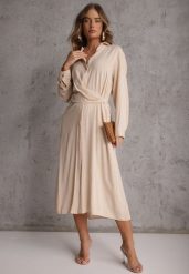 Beżowa Koszulowa Sukienka z Wiskozy z Asymetrycznym Drapowaniem i Guzikiem Hetasa. Brązowe sukienki damskie Renee, bez wzorów, z wiskozy, eleganckie, bez ramiączek. Za 119.99 zł.