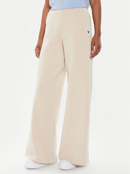 Guess Spodnie dresowe V4YB07 KCAY2 Beżowy Relaxed Fit. Brązowe spodnie dresowe damskie Guess, xl, z aplikacjami, z dresówki. Za 239.99 zł.