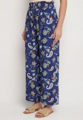 Niebieskie Spodnie z Bawełny z w Stylu Boho z Szerokimi Nogawkami i Gumką w Talii Jelvia. Niebieskie spodnie materiałowe damskie Born2be, bez wzorów, z bawełny. Za 39.99 zł.