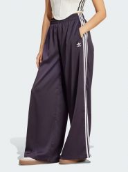 Adidas Spodnie dresowe w kolorze fioletowym rozmiar: 40. Różowe spodnie dresowe damskie Adidas, bez wzorów, z dresówki. Za 136.13 zł.