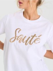 Bawełniana koszulka z połyskującymi aplikacjami - biały. Białe koszulki damskie Sinsay, l, z aplikacjami, z bawełny, bez kołnierzyka, bez ramiączek. Za 29.99 zł.