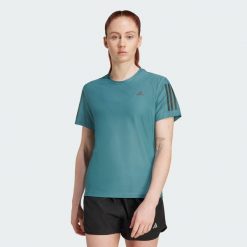 Koszulka Own The Run. Niebieskie koszulki damskie Adidas, l, bez wzorów, z materiału, bez kołnierzyka, bez ramiączek. Za 149.00 zł.