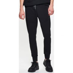 Dresowe joggery - Czarny. Spodnie dresowe chłopięce marki 4F. Za 89.99 zł.