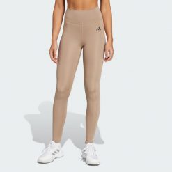 Długie legginsy Optimé Essentials Stash Pocket. Brązowe legginsy damskie Adidas, l, bez wzorów, z elastanu. Za 204.20 zł.