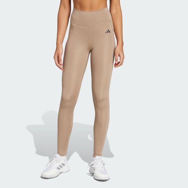 Długie legginsy Optimé Essentials Stash Pocket. Brązowe legginsy damskie Adidas, l, bez wzorów, z elastanu. Za 192.80 zł.