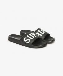 Superdry Core Pool Sliders - Klapki czarno-białe z miękkim paskiem. Czarne klapki damskie Superdry, bez wzorów, z poliesteru, bez obcasa, bez zapięcia. Za 190.15 zł.