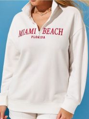 Bluza z haftowanym napisem - kremowy. Białe bluzy damskie Sinsay, l, bez wzorów, bez kaptura. W wyprzedaży za 33.99 zł.