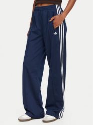 Adidas Spodnie dresowe Firebird KV5403 Niebieski Loose Fit. Niebieskie spodnie dresowe damskie Adidas, xl, bez wzorów, z dresówki. Za 299.99 zł.