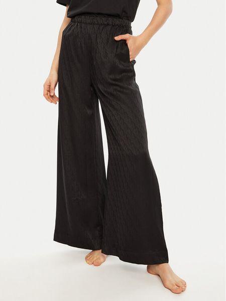 Calvin Klein Spodnie piżamowe 000QS7304E Czarny Relaxed Fit. Czarne piżamy damskie Calvin Klein, bez wzorów, z syntetyku, bez ramiączek. Za 169.99 zł.