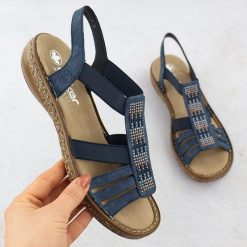 Sandały damskie na gumki granatowe Rieker 628G7-14. Sandały damskie Rieker, bez wzorów, ze skóry ekologicznej, bez obcasa, bez zapięcia. Za 254.99 zł.